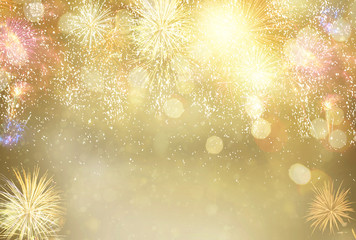Abstract festive winter bokeh background with fireworks and bokeh lights on gold