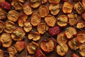 Sliced small dried apples on wooden surface