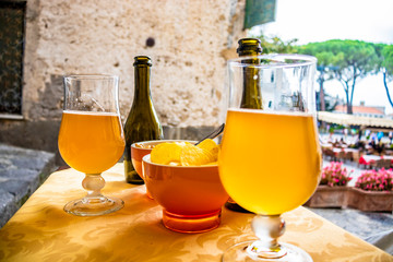 Aperitif with craft beer and chips, in a bar in the central square of Ravello. In the province of...