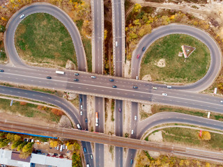 Aerial or top view of transport junction, asphalt roads with crossroad and circle intersections, city traffic cars from above