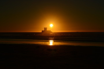 Naklejka premium St Ouen Bay, Jersey, U.K. Local 19th century landmark at sunset in Autumn.