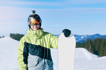 Fototapeta na wymiar snowboarder and snowboard, portrait on a background of mountains