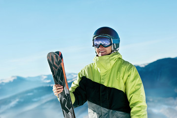 Portrait of a skier in the ski resort on the background of mountains and blue sky, Bukovel.  Ski...