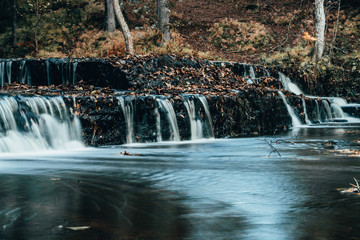 Forest river rapids in autumn day in Estonia