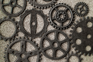 Gear wheels on glittering background