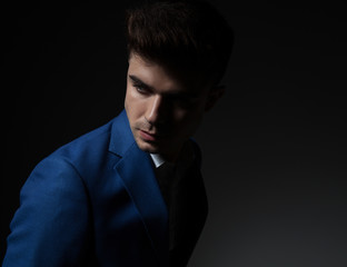 Fototapeta premium portrait of attractive smart casual man looking down and behind