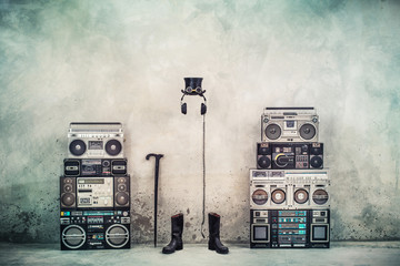 Retro old design ghetto blaster boombox radio cassette tape recorders, headphones, cylinder hat,...