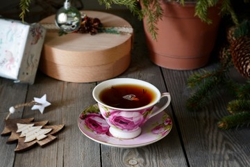 Delicious  Hot Cup of tea with christmas tree. Copy space. Christmas Background. Tea Time. Selective focus.