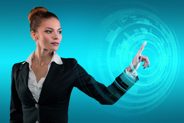Young business lady works with virtual graphic interface in futuristic office