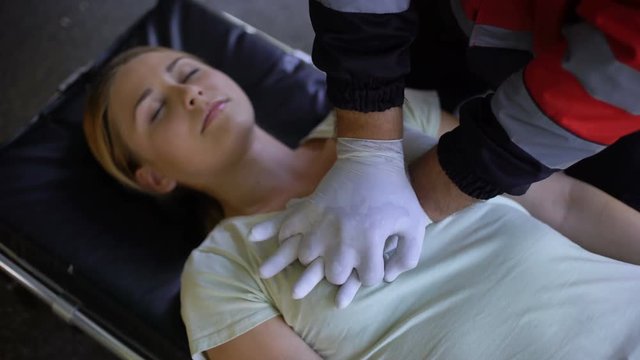 Doctor doing CPR to woman, patient death, mortality from road traffic accidents
