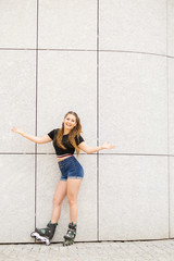 Young woman riding roller skates