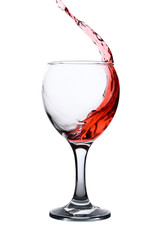Splash of wine in a wineglass on a white background.