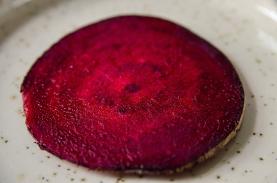 Fresh slice of beet root served on a plate, juicy red