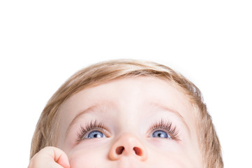 Adorable little boy looking up on a white background