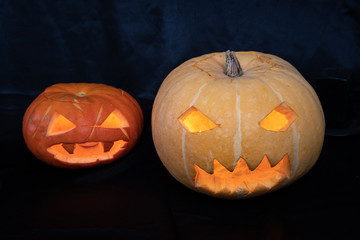 Two Halloween Pumpkins in a Dark Room