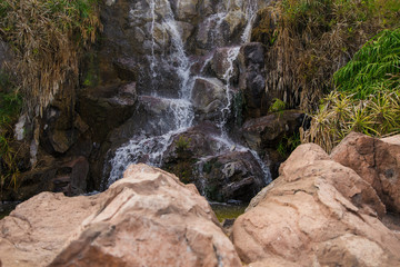 Naklejka na ściany i meble beautiful little waterfall with stones in tenerife
