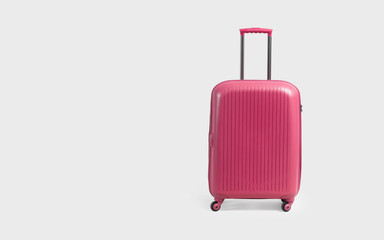 Pink trolley suitcase isolated on white