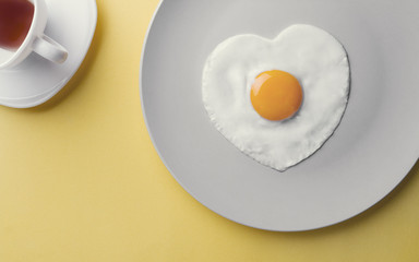 fried egg heart shape - healthcare concept