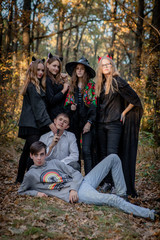 Teenagers in Halloween costumes in the woods