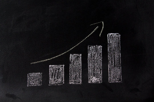 Growing graph on blackboard. Sales growth concept