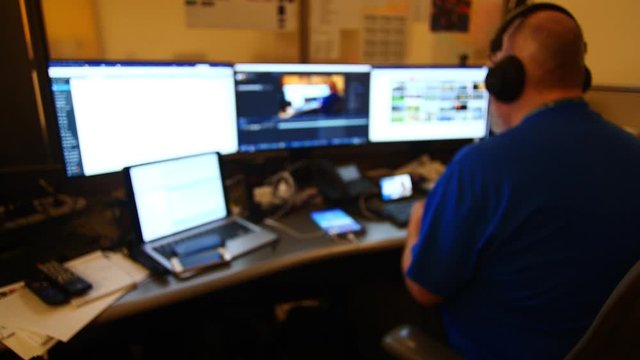 Man Working with Multiple Monitors Out of Focus 4K