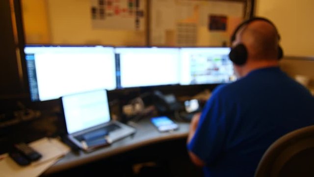 Man Working with Multiple Monitors Out of Focus 4K
