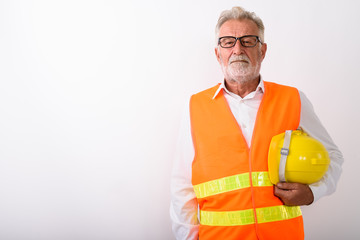 Studio shot of handsome senior bearded man construction worker h