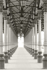 Corridor of symmetrical columns and lanterns