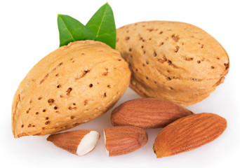 Almond with leaf on white background