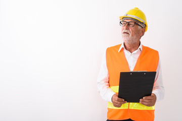Studio shot of handsome senior bearded man construction worker t