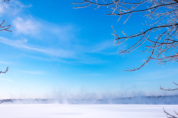 Fototapeta na wymiar Frozen lake blue sky