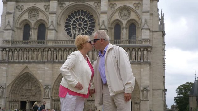 Senior couple in front of Notre Dame in Paris in 4k slow motion 60fps