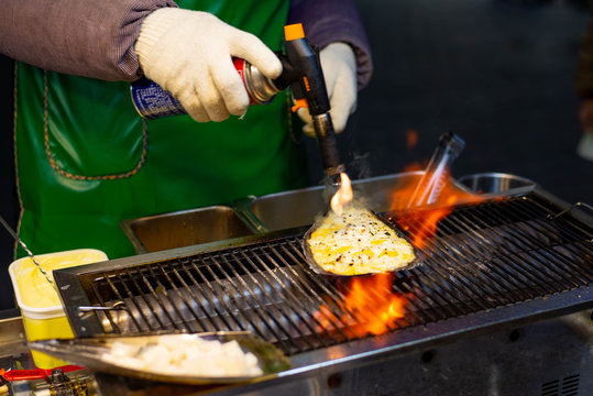 Chopped fresh scallops with cheese on street food at Myeong-dong, Korea.