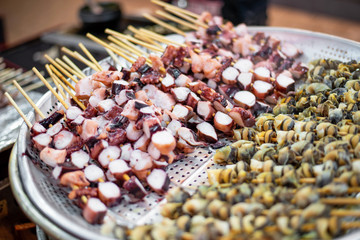 Squid skewers shop at the street food in Seoul.