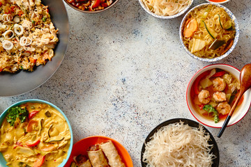 Asian food set. Noodles, fried rice with chicken, tom yum soup, spring rolls, deep fried fish and...