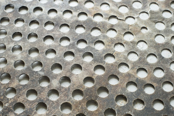 old steel sheet with circular perforations