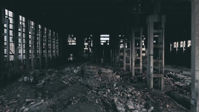 4k aerial view. Destroyed abandoned factory after the war, broken glass, destruction, frightening industrial composition
