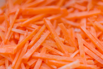 Carrot texture. Carrot background. Cut into pieces, straw.
