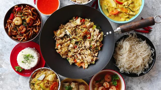 Asian oriental food composition in colorful dishware, served on stone, top view. Chinese, vietnamese, thai cuisine set. With copy space