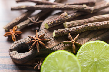 licorice root, lemon and anise on the table.
