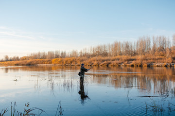 Fototapeta na wymiar Fisherman in the fall. Fisherman in Siberia.