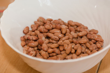 Red boiled beans. Beans in a white plate. Red beans close-up.