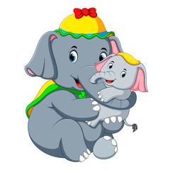 an elephant wearing a yellow hat and  playing with a little  elephant so fun
