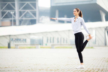 Fototapeta na wymiar Fitness. Woman Doing Workout Exercise On Street