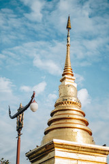 Fototapeta premium gold pagoda at Wat Phra That Chang Kam Worawihan at Nan National Museum, Nan, Thailand