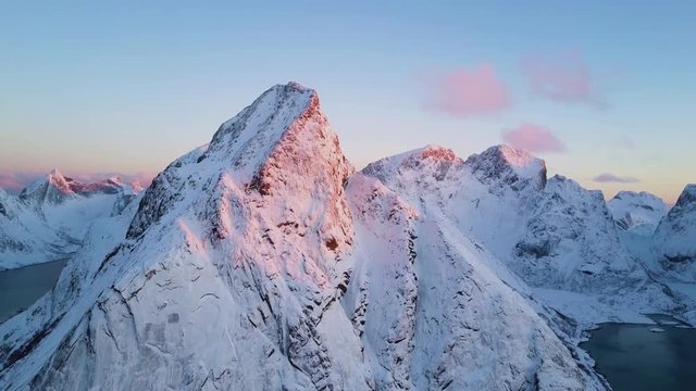 4k Sunrise drone - Snow covered mountains of Reine Norway.  Lofoten islands