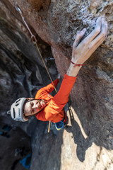 Obraz premium The last movements to reach the summit by a male climber. Rock climbing inside Andes mountains and valleys at Cajon del Maipo, an amazing place to enjoy rock climbing and mountaineering sports, Chile 