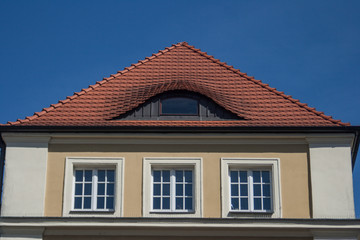 Old house with yellow wall and red roof