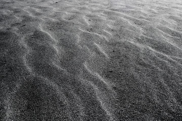 Sand texture waves. Nature pattern background. Black beach