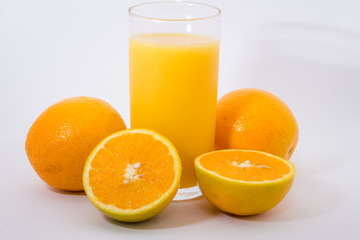 Some oranges in a basket on wooden background.
